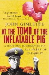Book cover of At the Tomb of the Inflatable Pig by John Gimlette