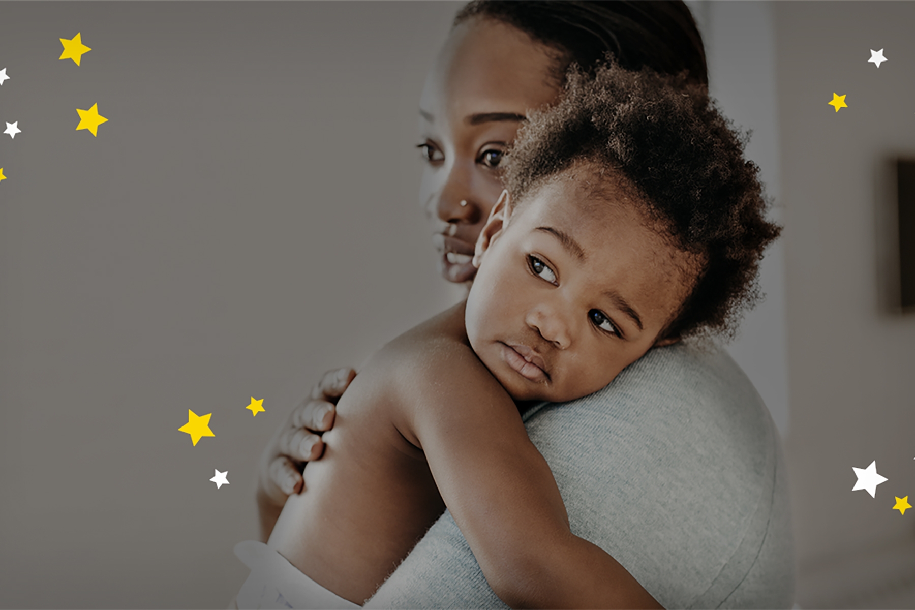 A photo of a mum holding her young child and comforting her before bedtime