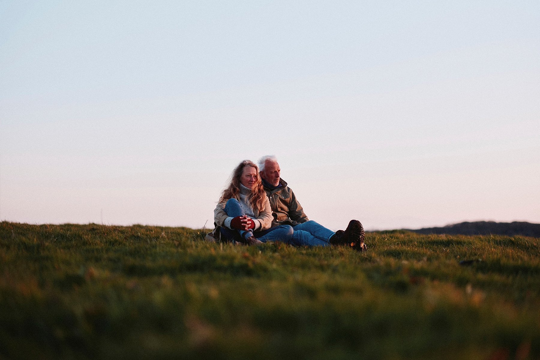 A photograph of Moth and Raynor Winn on top of a hill